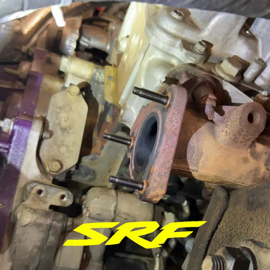 Old factory up pipe flange on Duramax engine with new SRF stud kit installed