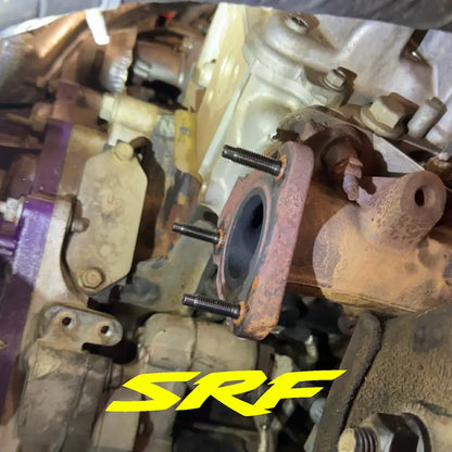Old factory up pipe flange on Duramax engine with new SRF stud kit installed